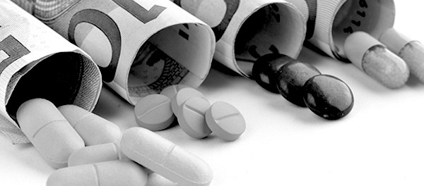 medical pills and tablets in euro bank notes money as a symbol of health costs